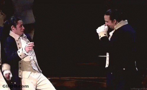 Two Men In Military Uniforms Smiling On Stage GIF