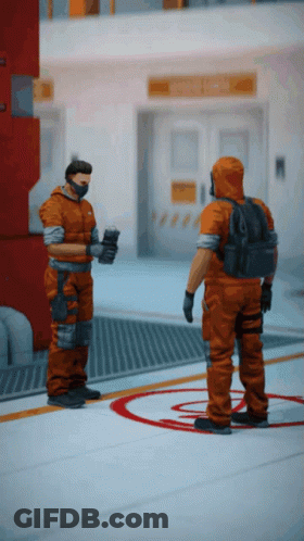 Two Men In Orange Jumpsuits Are Standing Next To Each Other In A Room GIF
