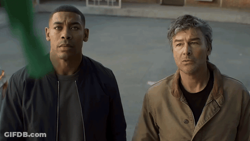 Two Men In Parking Lot Looking At Something GIF