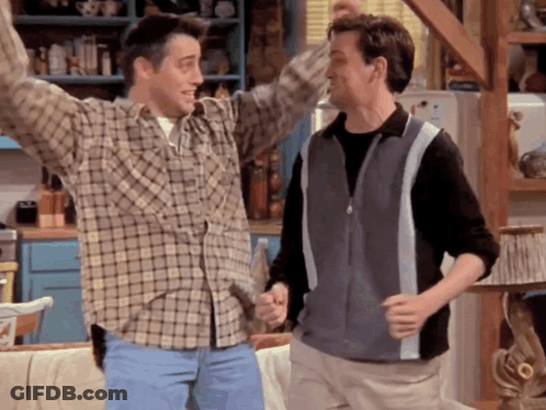 Two Men In Plaid Shirts Are Dancing Together GIF