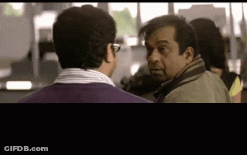 Two Men In Purple Sweaters Talking GIF