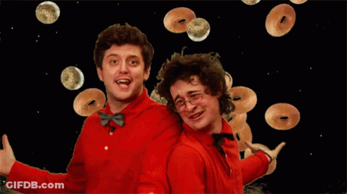 Two Men In Red Shirts And Bow Ties Are Surrounded By Donuts GIF