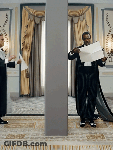 Two Men In Red Shirts Sitting GIF