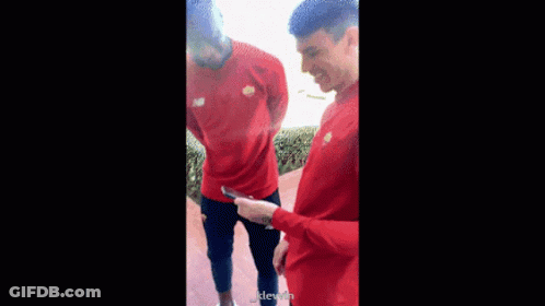 Two Men In Red Shirts Standing GIF