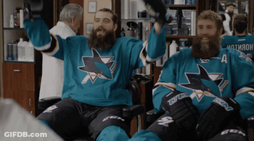 Two Men In Sharks Jerseys Sitting In Chair GIF