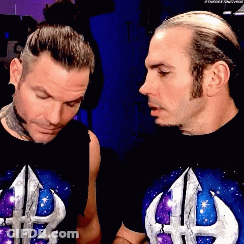 Two Men In Shirts With Letter H Looking At Each Other GIF