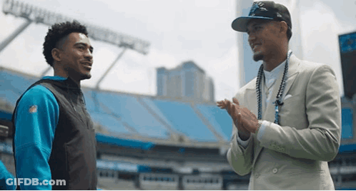 Two Men In Stadium One Wearing NFL Jersey GIF