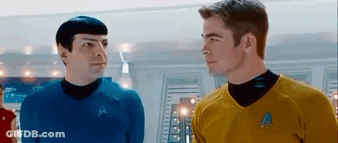 Two Men In Star Trek Uniforms Looking At Each Other GIF