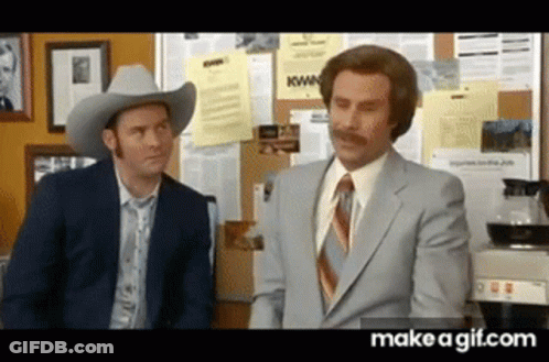 Two Men In Suits And Cowboy Hats Are Standing Next To Each Other And Talking . GIF