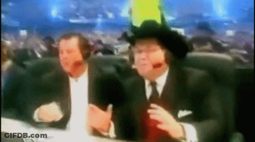 Two Men In Suits And Cowboy Hats At Table With Microphones GIF