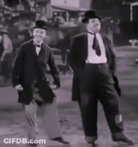 Two Men In Suits And Hats Are Dancing In A Black And White Photo GIF