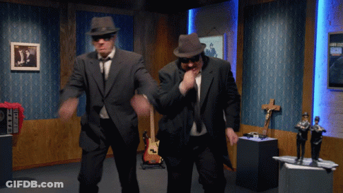 Two Men In Suits And Hats Are Dancing In A Room With A Sign That Says ' A ' On It GIF