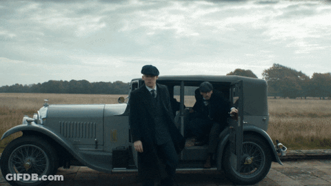 Two Men In Suits And Hats Getting Out Of Gray Car GIF