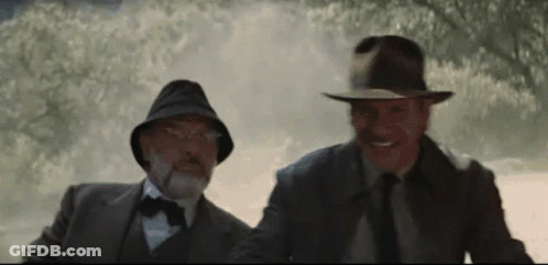Two Men In Suits And Hats In Foggy Forest GIF