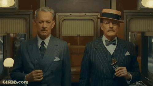 Two Men In Suits And Hats One Holding Seagrams GIF