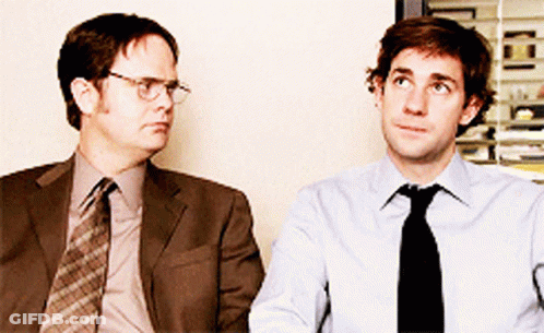 Two Men In Suits And Ties Are Sitting Next To Each Other And Looking Up GIF