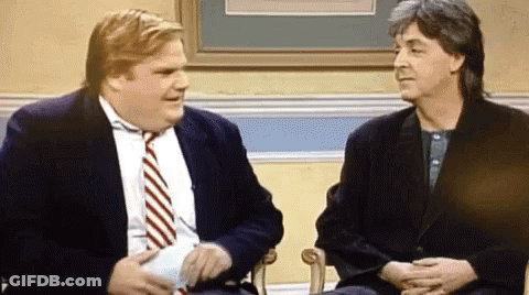 Two Men In Suits And Ties Are Sitting Next To Each Other In Chairs And Talking . GIF