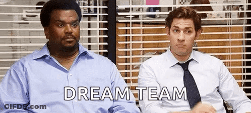 Two Men In Suits And Ties Are Sitting Next To Each Other In Front Of A Window With Blinds . GIF