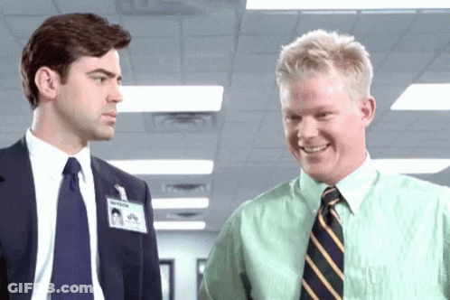 Two Men In Suits And Ties Are Standing Next To Each Other And One Has A Name Tag That Says ' Assistant ' On It GIF