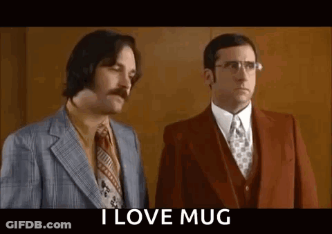 Two Men In Suits And Ties Are Standing Next To Each Other And One Of Them Is Holding A Mug . GIF
