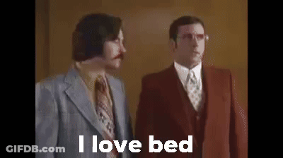 Two Men In Suits And Ties Are Standing Next To Each Other And They Are Talking About Bed . GIF