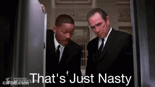 Two Men In Suits And Ties Are Standing Next To Each Other In A Room . GIF