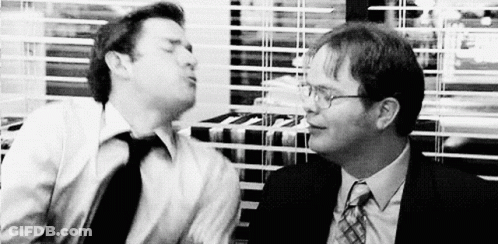 Two Men In Suits And Ties Are Standing Next To Each Other In An Office . GIF
