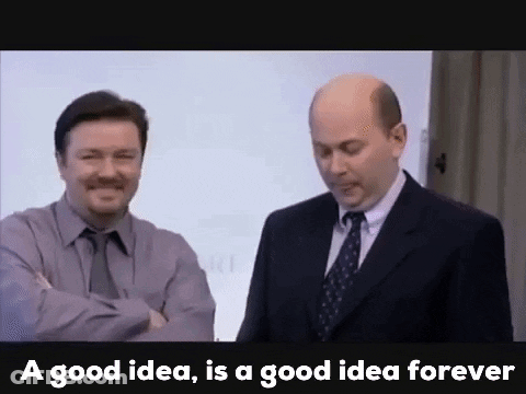 Two Men In Suits And Ties Are Standing Next To Each Other In Front Of A White Board . GIF
