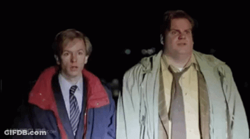 Two Men In Suits And Ties Are Standing Next To Each Other In The Dark And Looking Up . GIF