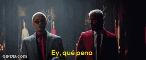 Two Men In Suits And Ties Are Standing Next To Each Other With The Words Ey Qué Pena Written In Yellow GIF
