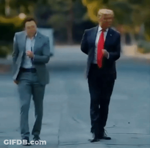 Two Men In Suits And Ties Are Walking Down The Street . GIF