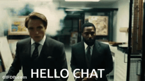 Two Men In Suits And Ties Are Walking In A Hallway With The Words Hello Chat On The Bottom GIF