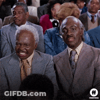 Two Men In Suits And Ties At Table With Drinks GIF