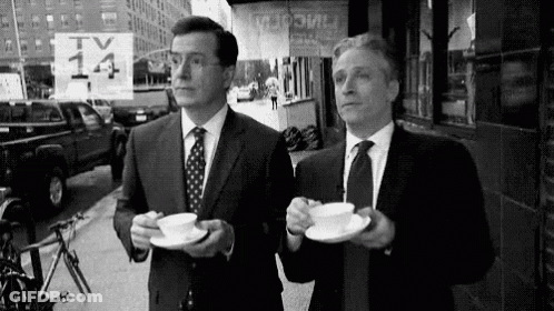 Two Men In Suits And Ties Drinking Coffee GIF