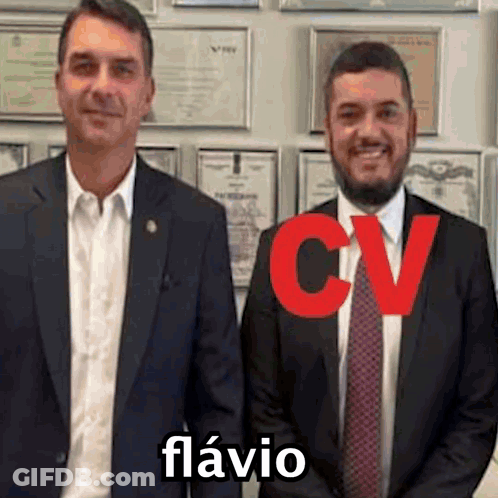 Two Men In Suits And Ties In Front Of Certificates GIF
