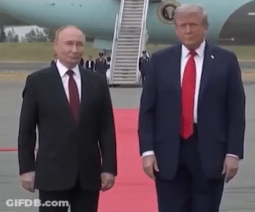 Two Men In Suits And Ties On Red Carpet GIF