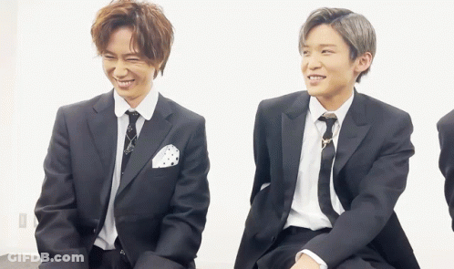 Two Men In Suits And Ties Sitting Together GIF