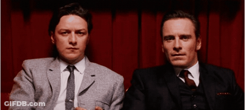 Two Men In Suits And Ties Sitting Together GIF