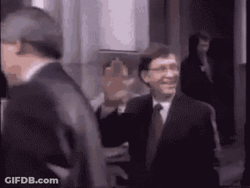 Two Men In Suits And Ties Smiling GIF
