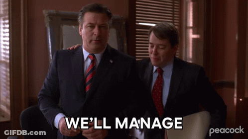 Two Men In Suits And Ties Standing Next To Each Other With The Words We 'Ll Manage Written On The Screen GIF