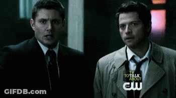 Two Men In Suits And Ties Standing Together GIF