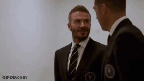 Two Men In Suits And Ties Talking GIF