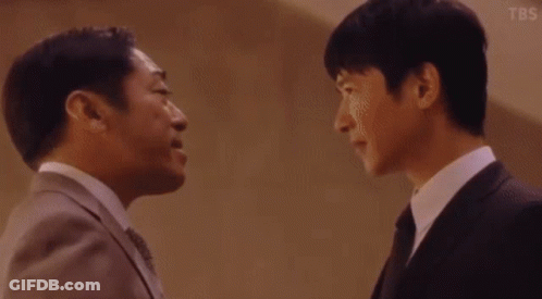 Two Men In Suits And Ties Talking GIF