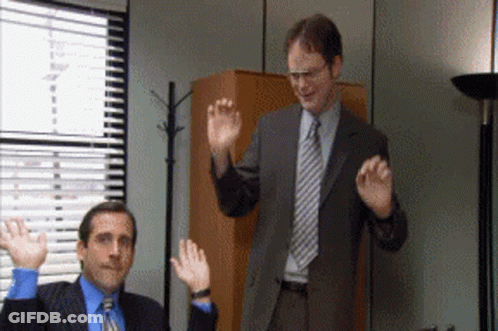 Two Men In Suits And Ties Waving GIF
