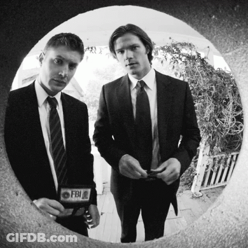 Two Men In Suits And Ties With A Fbi Badge On Their Chests GIF