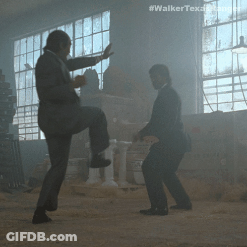 Two Men In Suits Are Dancing In A Dark Room With The Hashtag #Walkertexasrangers GIF