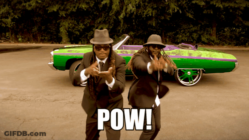 Two Men In Suits Are Dancing In Front Of A Green And Purple Car That Says Pow On It GIF