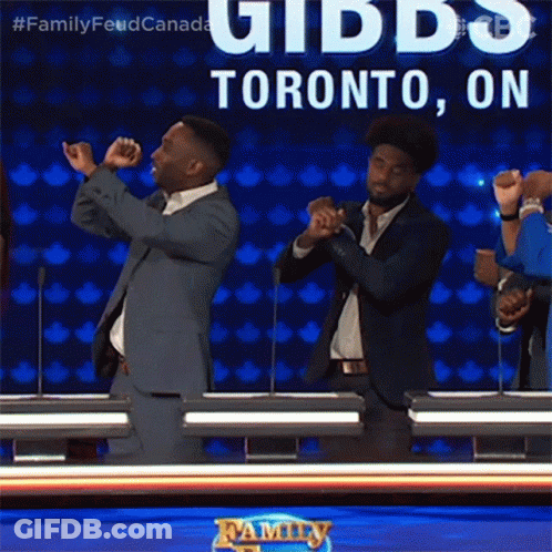 Two Men In Suits Are Dancing In Front Of A Sign That Says Toronto On It GIF