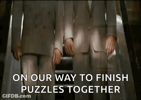 Two Men In Suits Are Riding An Escalator And The Words On Our Way To Finish Puzzles Together Are Displayed GIF