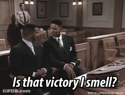 Two Men In Suits Are Sitting In A Courtroom With The Caption Is That Victory I Smell ? GIF